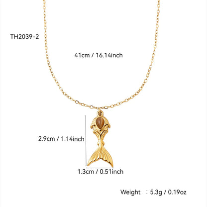 Gold necklace with mermaid tail pendant and measurements on a white background